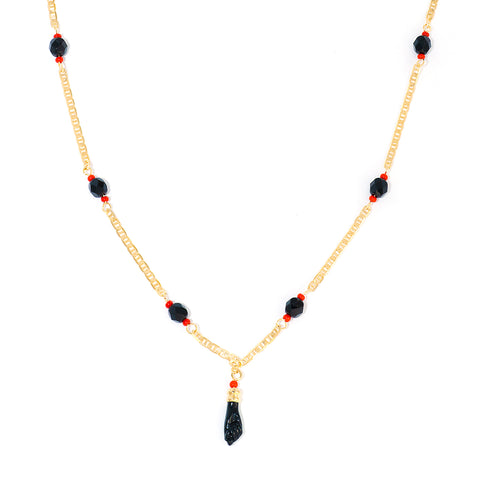 The Unisex Azabache Necklace, designed for both kids and adult women, features a 14K gold-filled chain adorned with black and red beads, centered around a striking black pendant for spiritual protection.